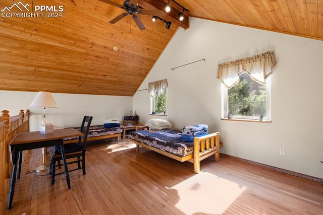 bedroom featuring wood ceiling, multiple windows, beamed ceiling, and hardwood / wood-style floors