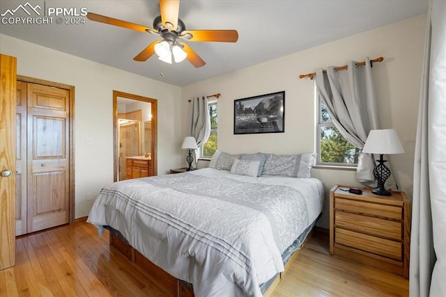 bedroom with light hardwood / wood-style flooring, connected bathroom, and ceiling fan