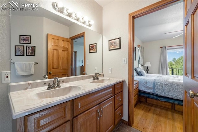 bathroom with dual vanity and hardwood / wood-style floors