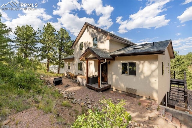 rear view of property featuring a deck