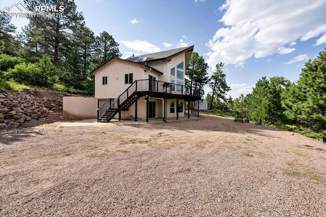 back of house with a wooden deck