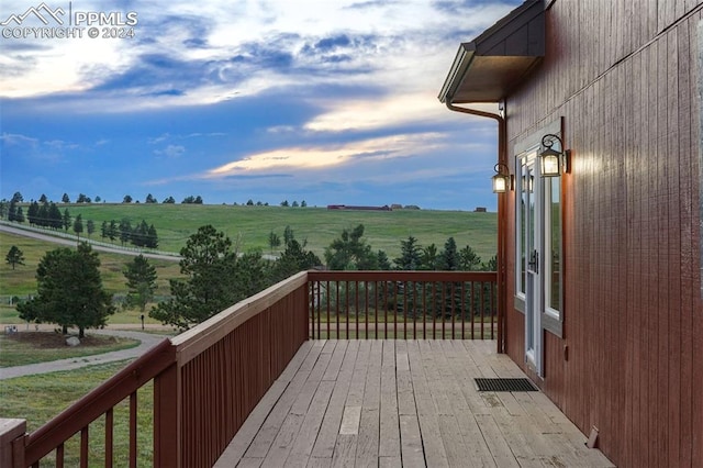 wooden deck featuring a rural view