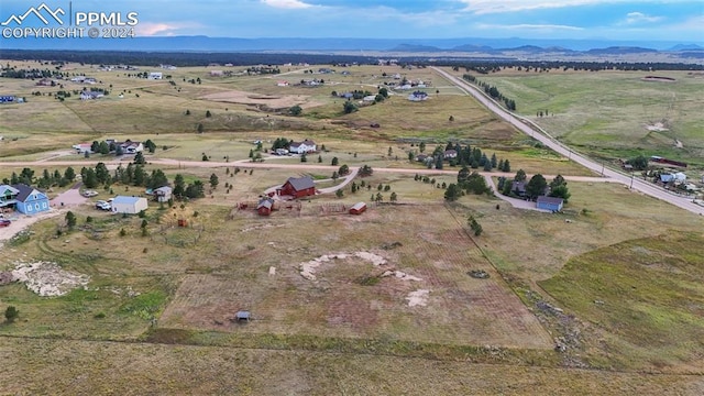 birds eye view of property featuring a rural view and a mountain view