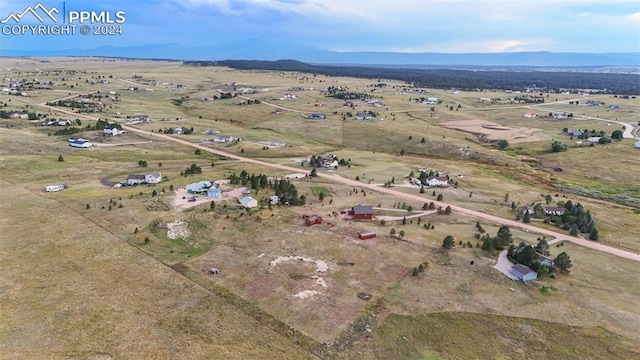 aerial view featuring a mountain view and a rural view