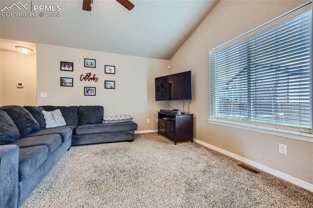 carpeted living room featuring ceiling fan and vaulted ceiling