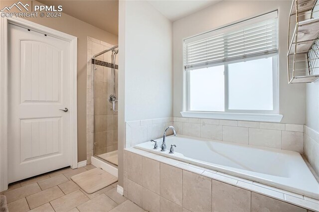 bathroom featuring independent shower and bath and tile patterned floors