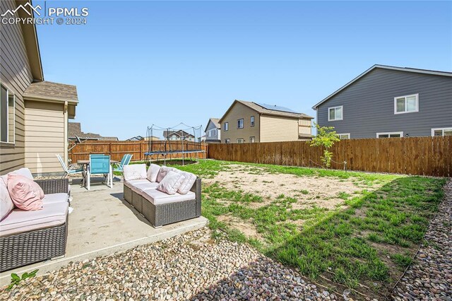 view of yard with an outdoor hangout area, a patio area, and a trampoline