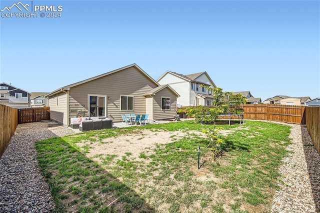 back of property with a lawn, a patio, and an outdoor hangout area