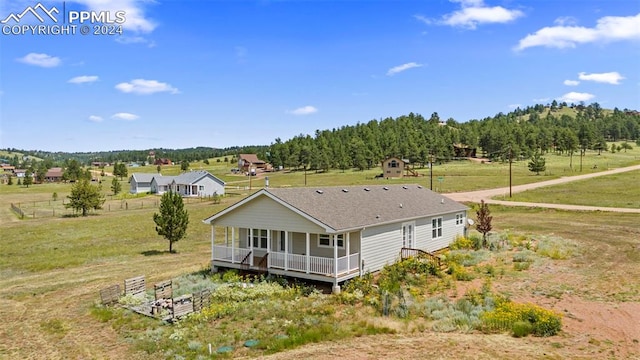 rear view of house featuring a yard