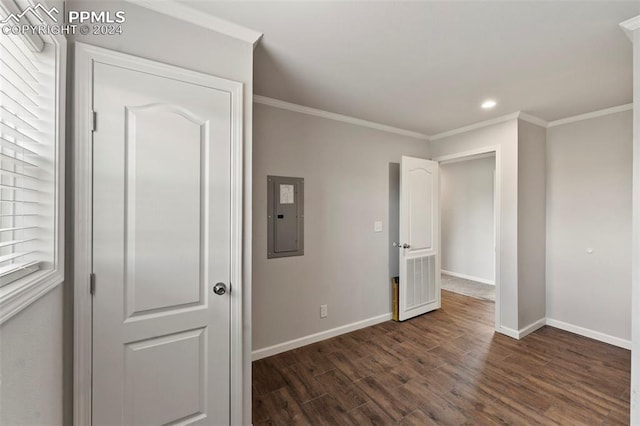 unfurnished bedroom featuring crown molding, dark wood-type flooring, and electric panel