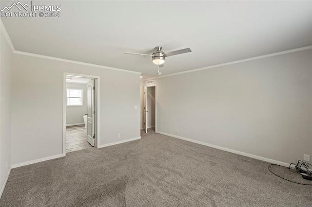 unfurnished bedroom with light colored carpet, crown molding, and ceiling fan