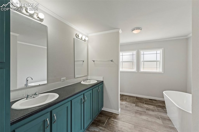 bathroom featuring dual vanity, a bathtub, crown molding, and tile patterned floors