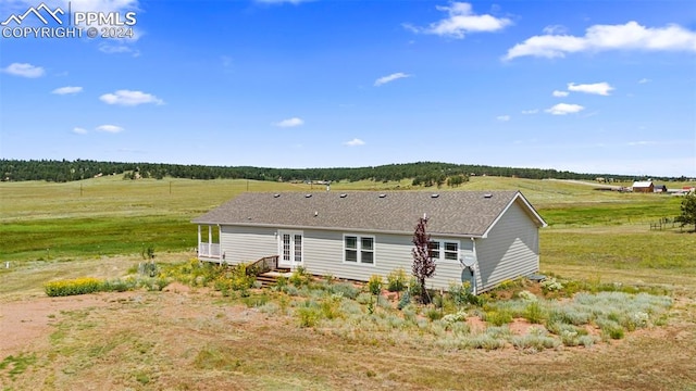 rear view of house with a rural view