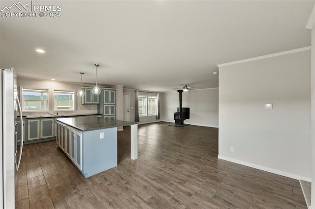 kitchen featuring dark hardwood / wood-style floors, gray cabinets, hanging light fixtures, a breakfast bar area, and stainless steel fridge