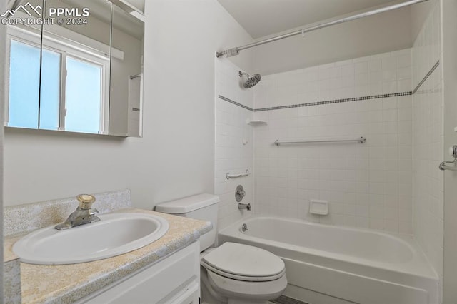 full bathroom featuring toilet, tiled shower / bath combo, and vanity