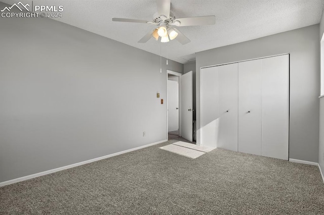 unfurnished bedroom with a closet, carpet, a textured ceiling, and ceiling fan