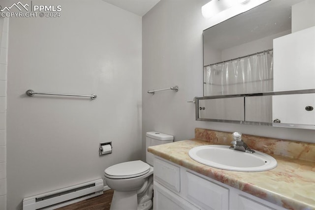 bathroom featuring walk in shower, hardwood / wood-style floors, vanity, a baseboard heating unit, and toilet