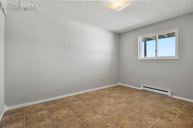 unfurnished room with a textured ceiling and baseboard heating