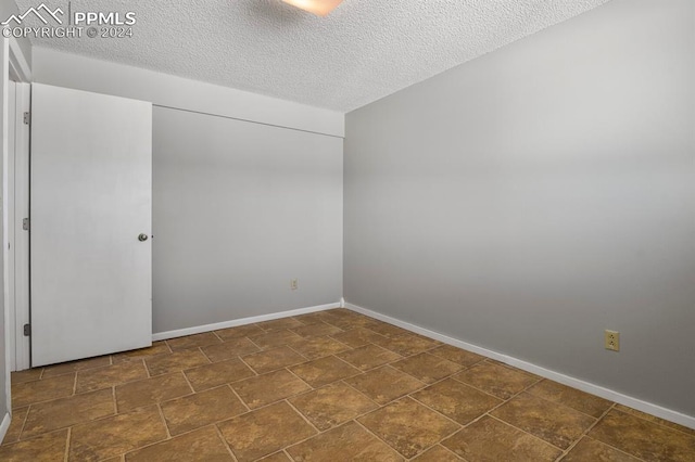 empty room with a textured ceiling