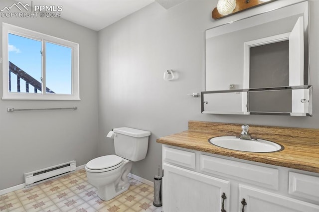 bathroom with baseboard heating, vanity, and toilet