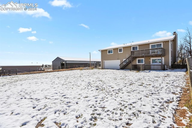 view of snow covered back of property