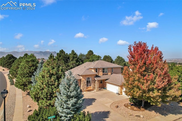 view of front of home with a mountain view and a garage