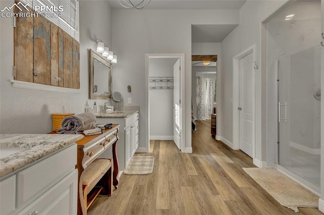 bathroom featuring vanity, hardwood / wood-style flooring, and walk in shower