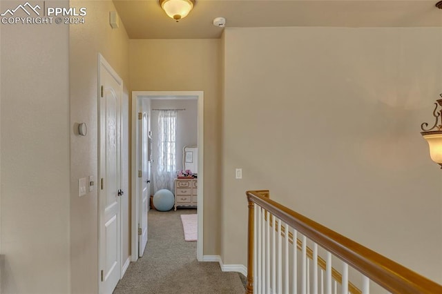 hall with light colored carpet