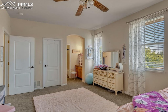 bedroom with carpet flooring, ensuite bathroom, and ceiling fan