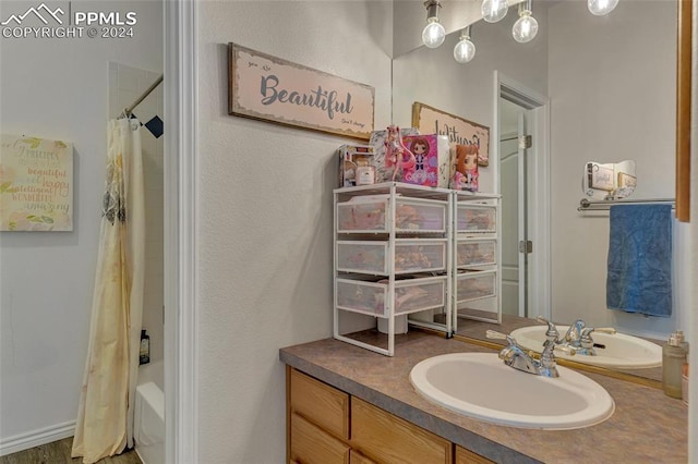 bathroom with vanity and shower / bathtub combination with curtain