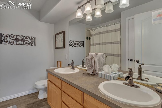 bathroom featuring hardwood / wood-style floors, vanity, toilet, and a shower with shower curtain