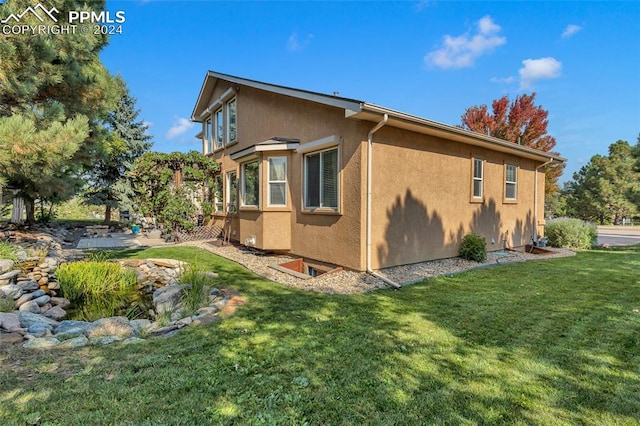 view of home's exterior with a lawn