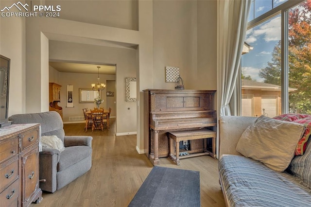 sitting room featuring a notable chandelier and light hardwood / wood-style floors