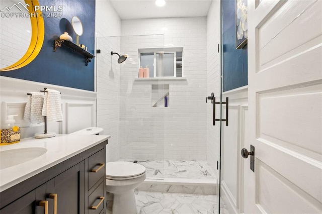 bathroom with vanity, tile patterned flooring, a tile shower, and toilet