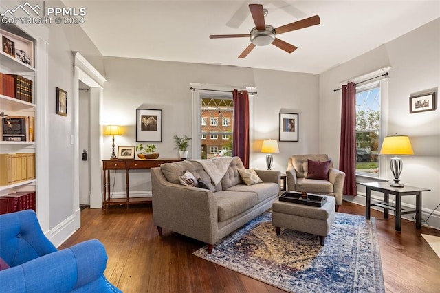 living room with dark wood-type flooring and ceiling fan