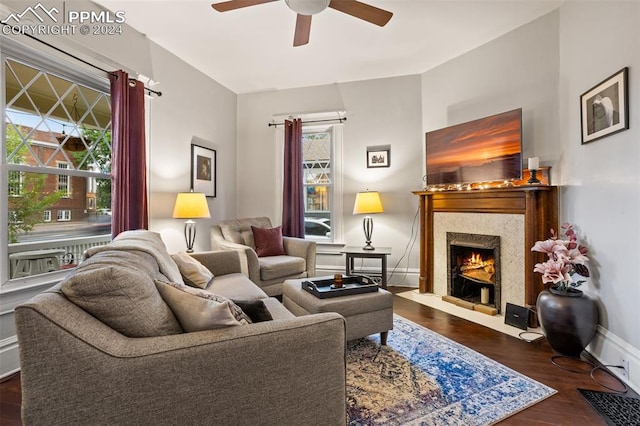 living room with dark wood-type flooring and ceiling fan