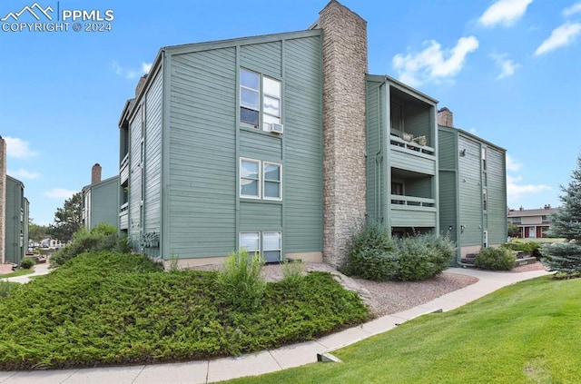 view of side of property with a yard