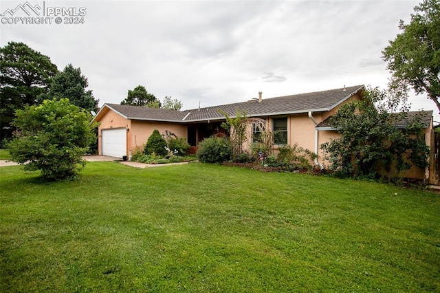 single story home featuring a front lawn and a garage