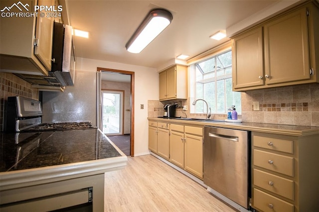 kitchen featuring tasteful backsplash, stainless steel dishwasher, and stove