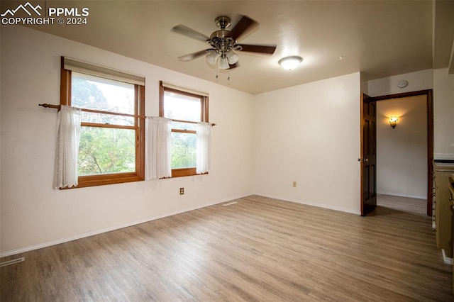 spare room featuring ceiling fan and wood-type flooring