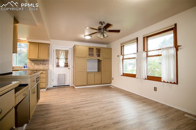 kitchen featuring backsplash, light wood-type flooring, ceiling fan, and light brown cabinets