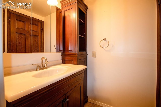 bathroom with vanity and hardwood / wood-style floors