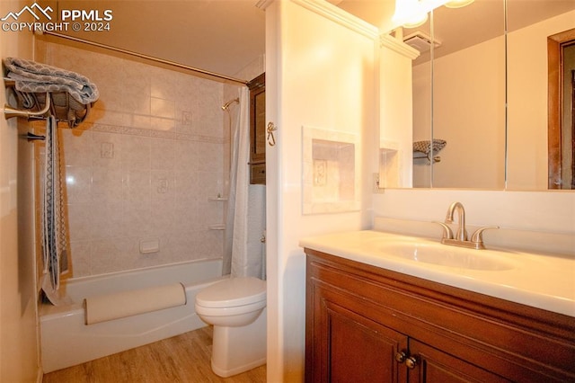 full bathroom with hardwood / wood-style floors, shower / bathtub combination with curtain, vanity, and toilet