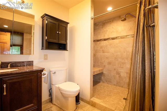 bathroom with a shower with shower curtain, vanity, toilet, and tile patterned flooring