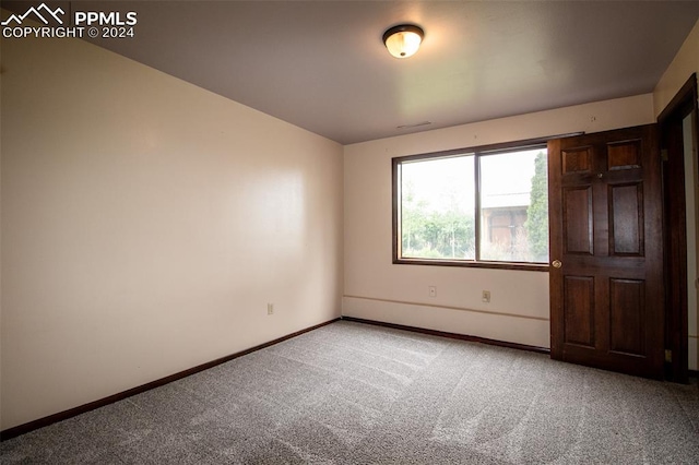 unfurnished bedroom featuring light carpet