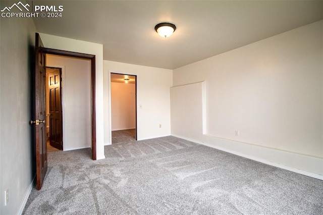 unfurnished bedroom featuring a closet and carpet floors