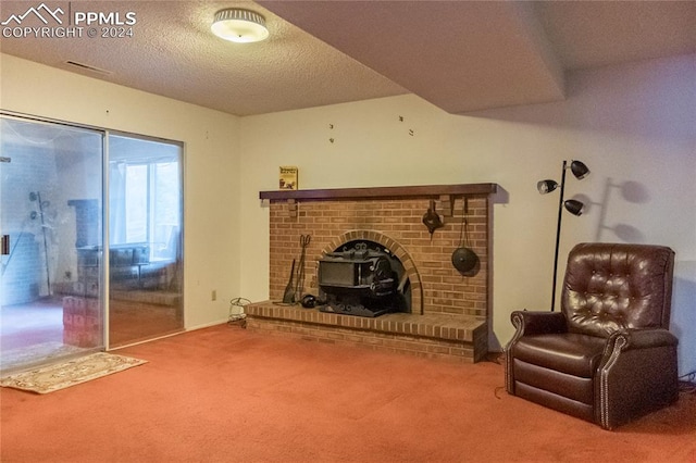 living room with carpet flooring, a wood stove, a fireplace, and a textured ceiling