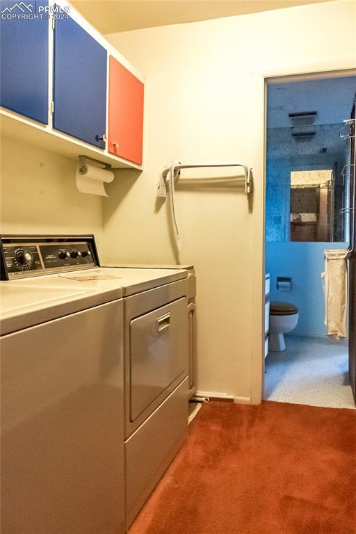 laundry room with independent washer and dryer and carpet flooring