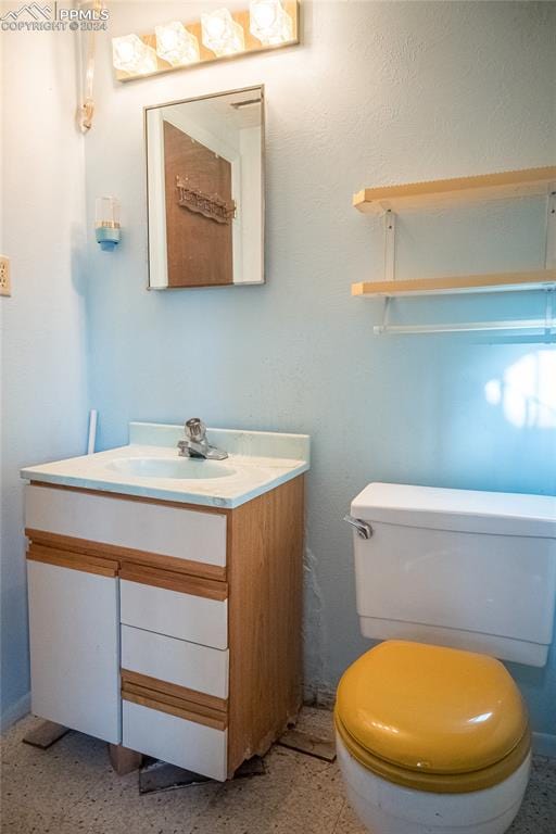 bathroom featuring vanity and toilet