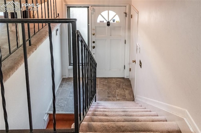 stairway with tile patterned floors